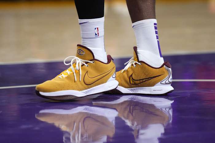 Los Angeles Lakers forward LeBron James's gold and maroon Nike sneakers.